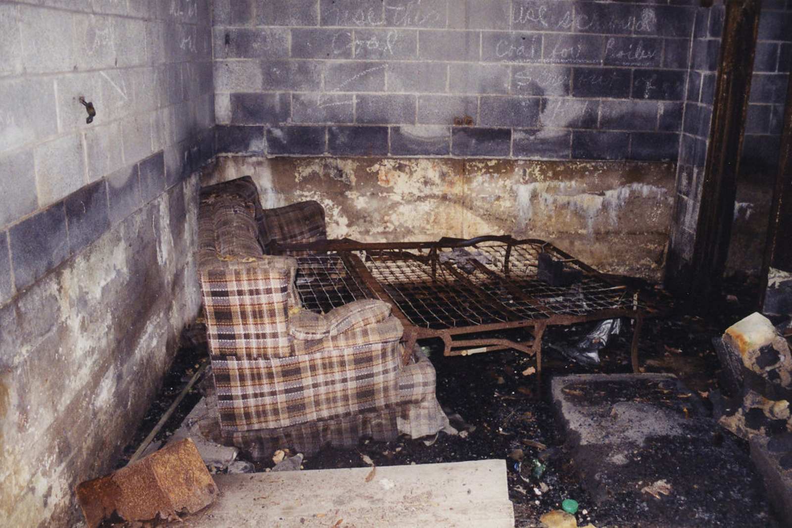 Fire damage restoration technician cleaning soot from a wall in a Miami home